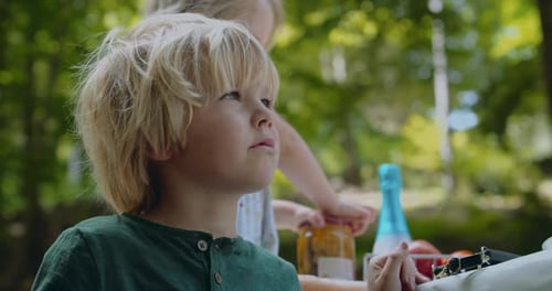 Blond-haired Child at a Picnic in Park