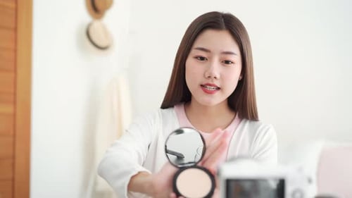 Young Woman Demonstrates Makeup Compact for Beauty Vlog