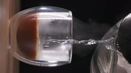 Hot Water Pouring Over Orange Slice in Glass