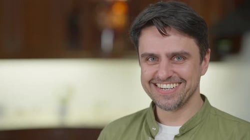 Closeup Smiling Face of Cheerful Caucasian Man on the Right Posing Indoors at Home
