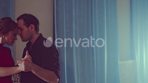 Young Couple Dancing Tango. Professional Girl in Red Dress and Man Dancing Latin. Modern Studio