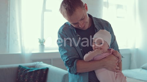 Loving Father Holding Adorable Baby in Bright Home