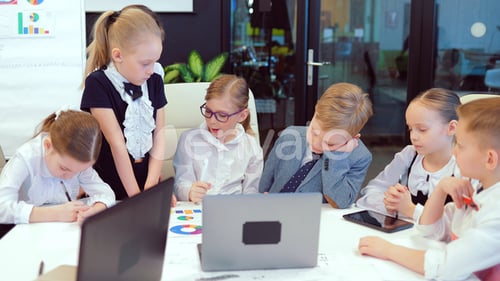 Young and Bright Modern Small Creative Children Business. Modern Office. Children Discuss Business