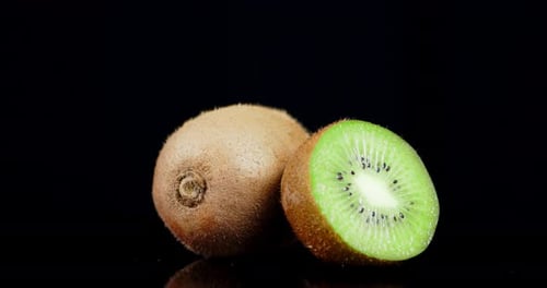 Half and Whole Kiwi Rotate Slowly