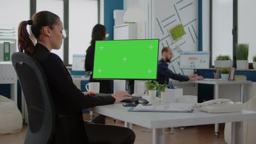 Businesswoman Using Computer with Horizontal Green Screen
