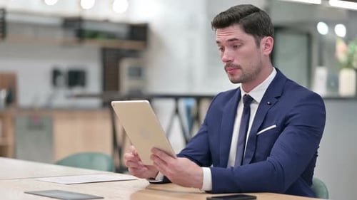 Professional Man on Tablet Video Call in Office