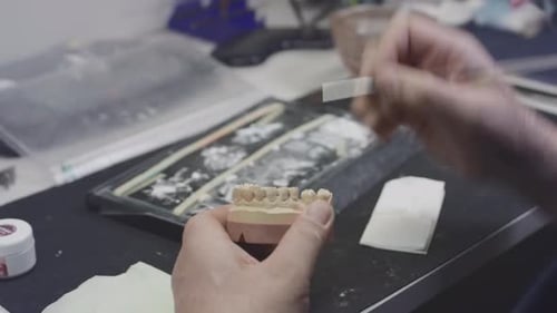 Dental Technician Working on Teeth in a Lab
