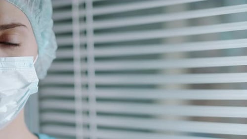 Healthcare Professional Wearing Blue Surgical Cap and Mask