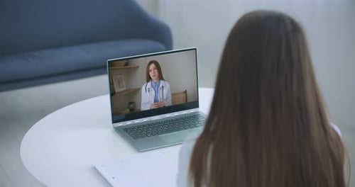 Woman Telehealth Appointment with Doctor on Laptop