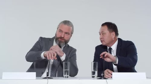 Businessmen Speaking at a Corporate Conference