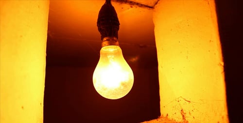 Lightbulb Glowing in Dark, Empty Room