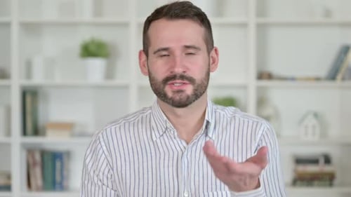 Man Talking and Waving on Video Call