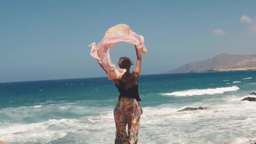 Beautiful Young Woman Girl Holding Fabric Pareo Sarong at Wind in a Summer Vacation Sea and