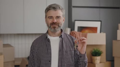 Man Holding House Keys in New Home