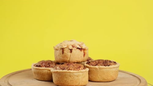 baked portion dish quiche with chicken and mushrooms on a wooden board