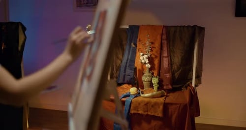 Young Woman Artist Paints a Still Life Objects are on the Table