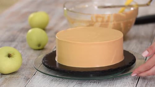 Decorating Cake with Tan Icing and Green Apples