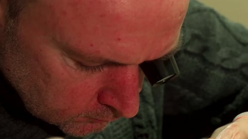 Watchmaker Repairing a Watch with Magnifying Glass