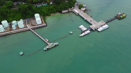 Aerial view from drone of commercial ship and cruise ship parked in the marina.