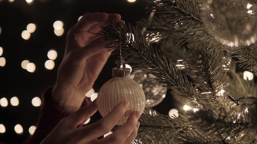 Decorating Christmas Tree with White Ornament