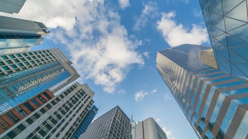 Low Angle of Skyscrapers Against Cloudy Blue Sky