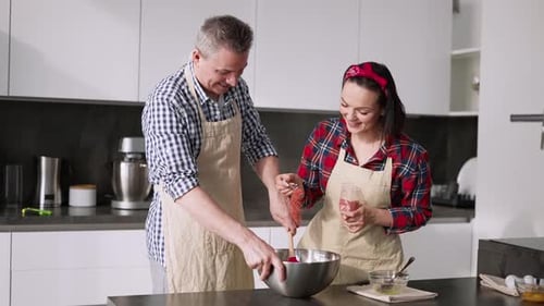 European Couple Cooking Together with Fun Add Flavour