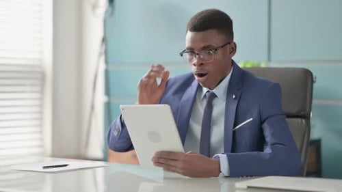 Young African Businessman Reacting to Loss on Tablet in Office