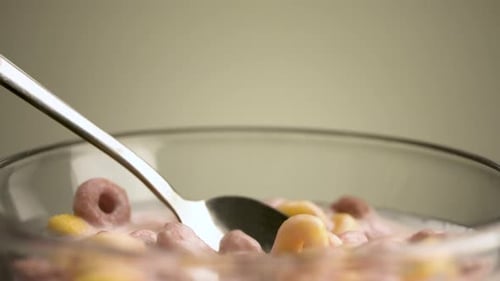 Cereal Rings with Milk and Spoon in Bowl
