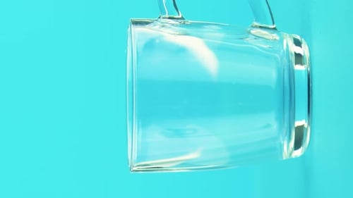 Juice Fills Clear Mug Against Blue Background