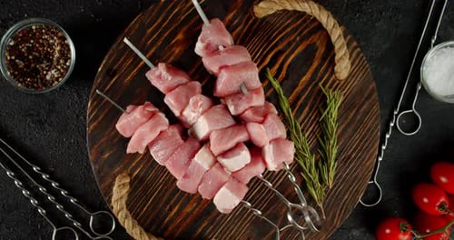 Raw Pork Kebab on Skewers on Tray Slowly Rotates.