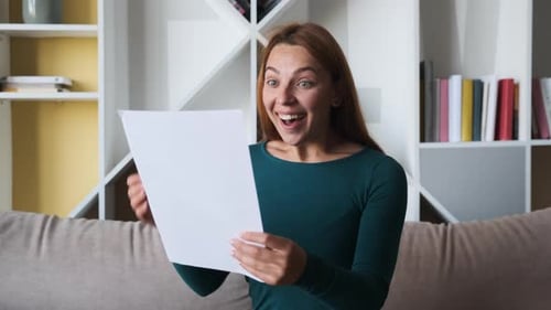 Woman Celebrates Reading Good News at Home