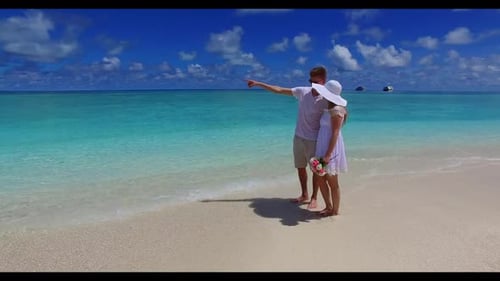 Young couple in love on relaxing sea view beach wildlife by shallow sea and white sandy background o