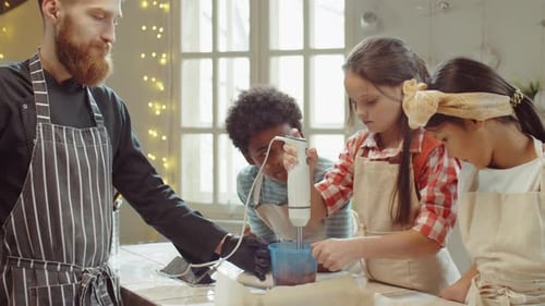 Little Girl Using Hand Blender during Culinary Class