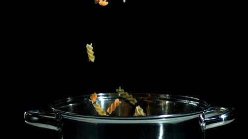 Tri-Color Rotini Pasta Falling into Shiny Pot