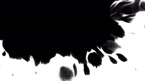 Black Ink Spreads Abstractly on White Surface