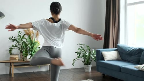 Woman Practicing Yoga in Bright Living Room