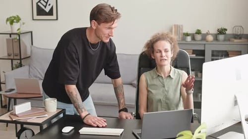 Man and Woman Collaborating in Home Office