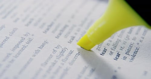 Close-up of marker pen highlighting text