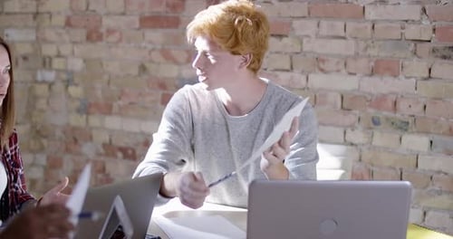 Portrait of Confident Caucasian Man Discussing Startup with Multiethnic Colleagues. Handsome Redhead