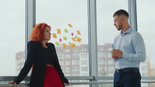 Professionals Brainstorming Ideas Using Sticky Notes in Office