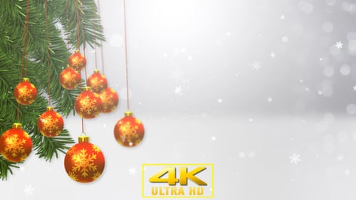 Festive Christmas Tree Branches with Ornaments and Falling Snow