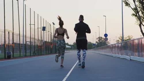 Rear view of a couple jogging