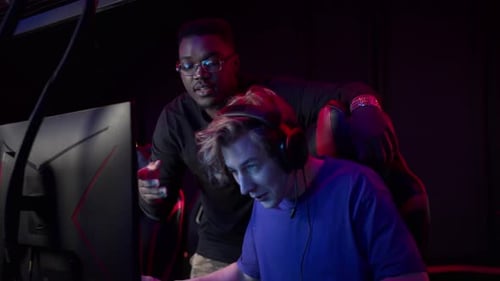 Two Young Adults Playing Video Games Together