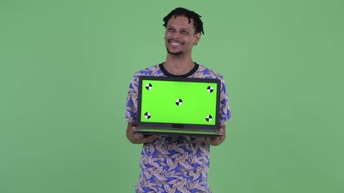Young Adult Holds Laptop with Green Screen