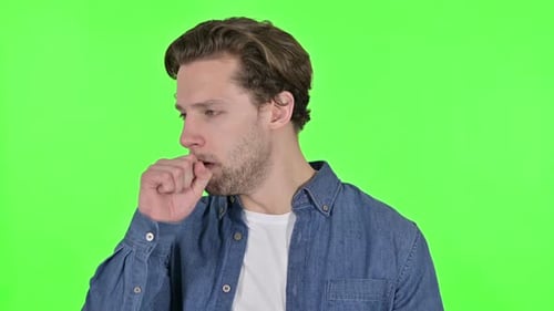 Portrait of Sick Young Man Coughing on Green Chroma Key