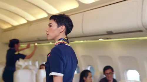 Flight Attendants Working Inside Airplane Cabin