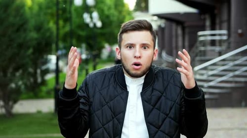 Young Handsome Man Expressing Astonishment and Admiration on the Street
