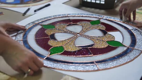 Artists Crafting Stained Glass Art in Workshop