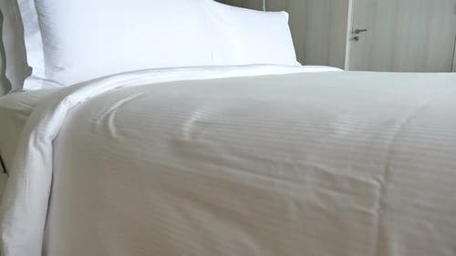 Clean Bedroom with White Bedding and Pillows