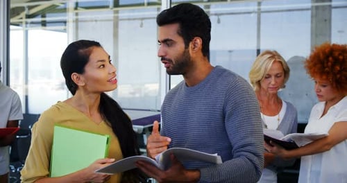 Team Discussing Documents in a Modern Office